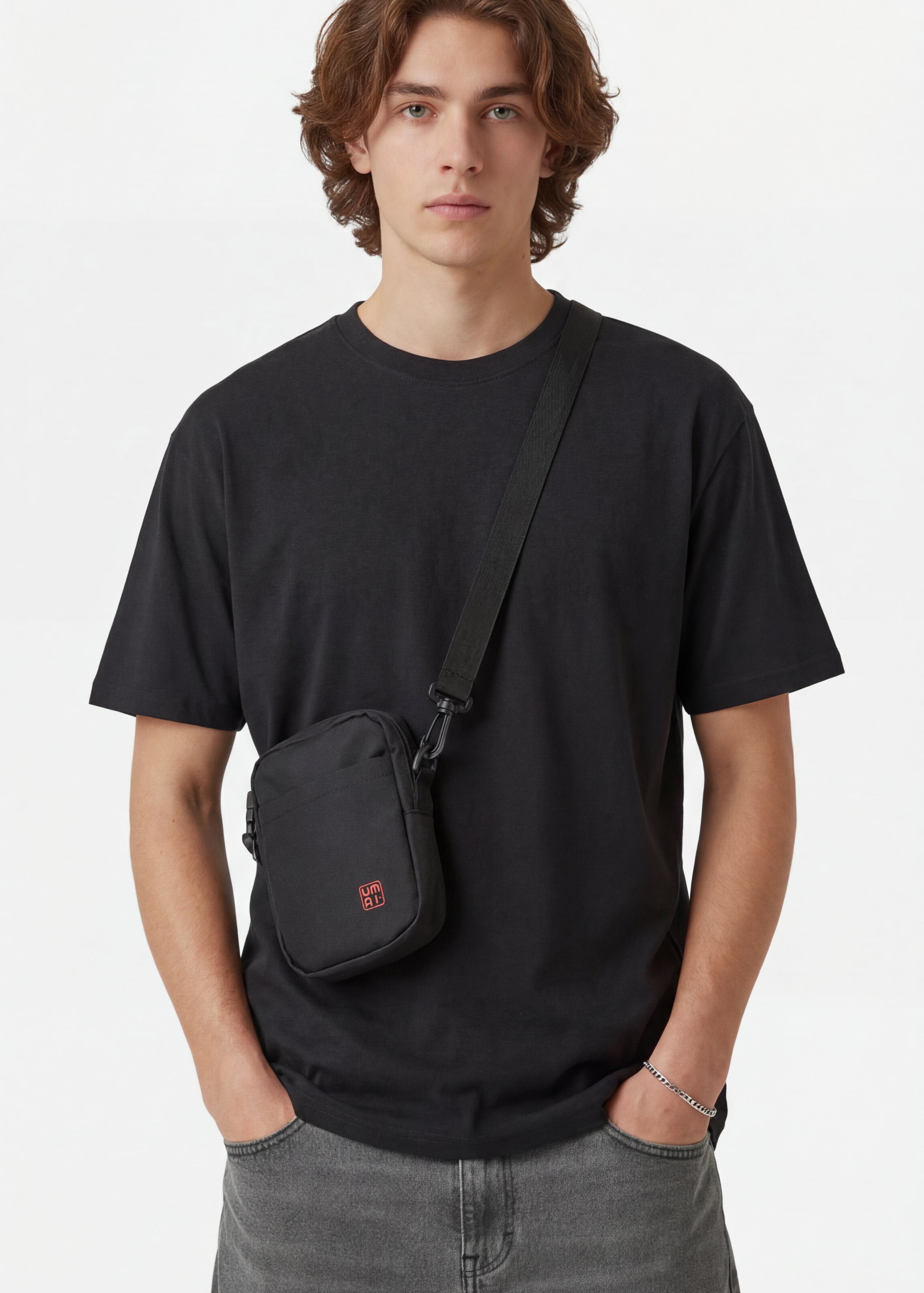 wearing_the_cross_body_bag_he_is_also_wearing_just_a_plain_black_t-shirt_and_a_silver_bracelet.png